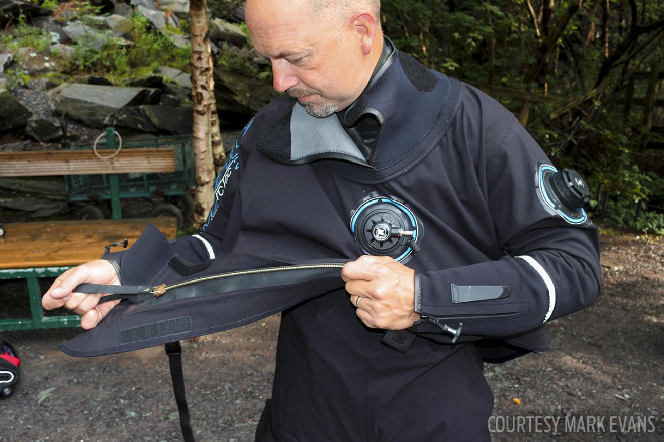 ScubaLab test diver puts on a Camaro drysuit during the gear test