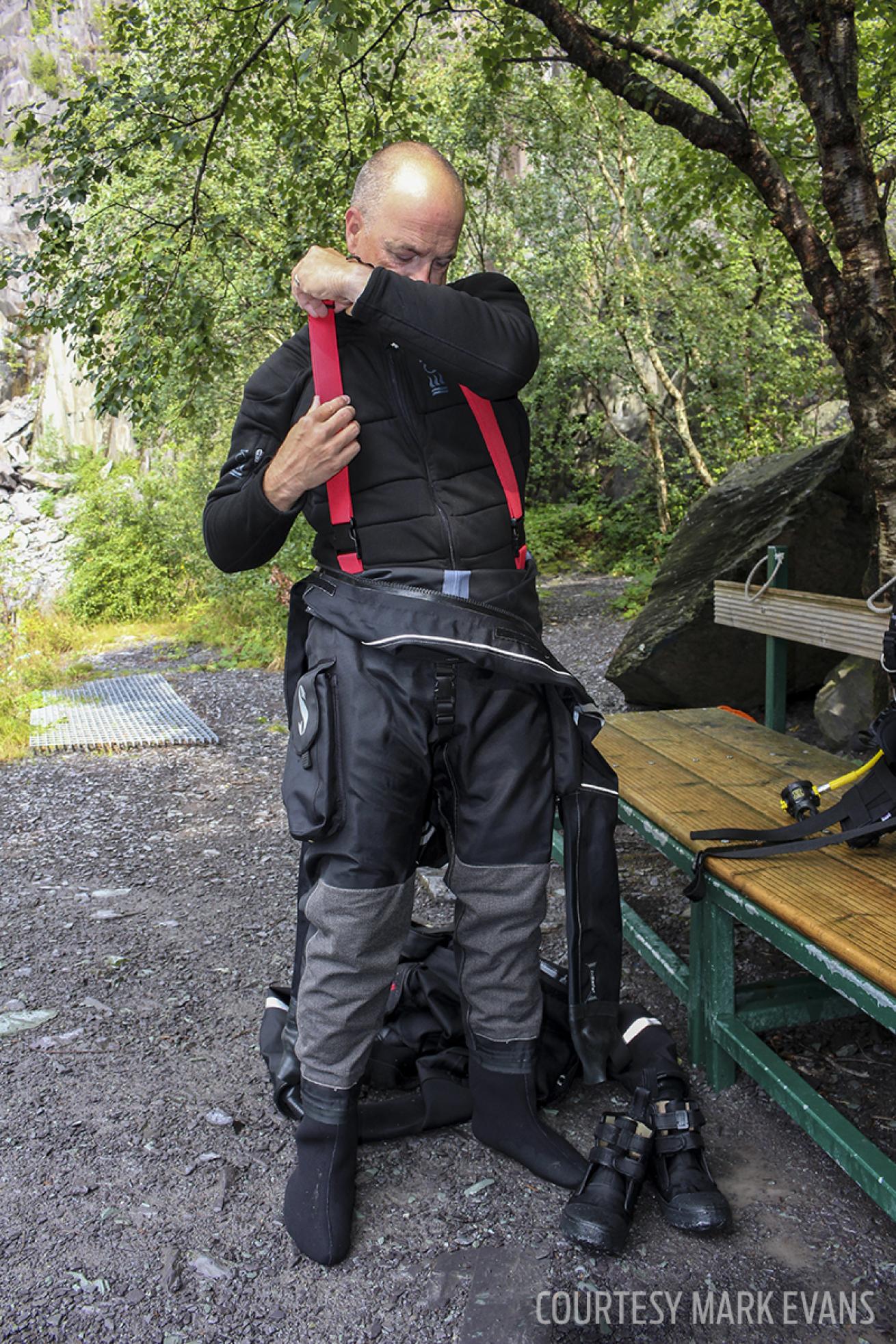 ScubaLab diver getting into a drysuit