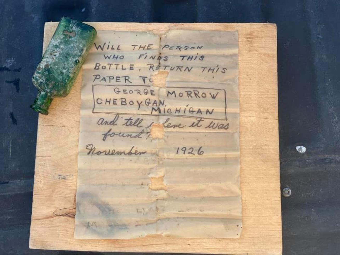 Waterlogged note next to a small green bottle