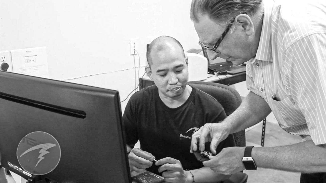 Founder and former CEO Bruce Partridge consults with one of Shearwater’s mechanical designers.