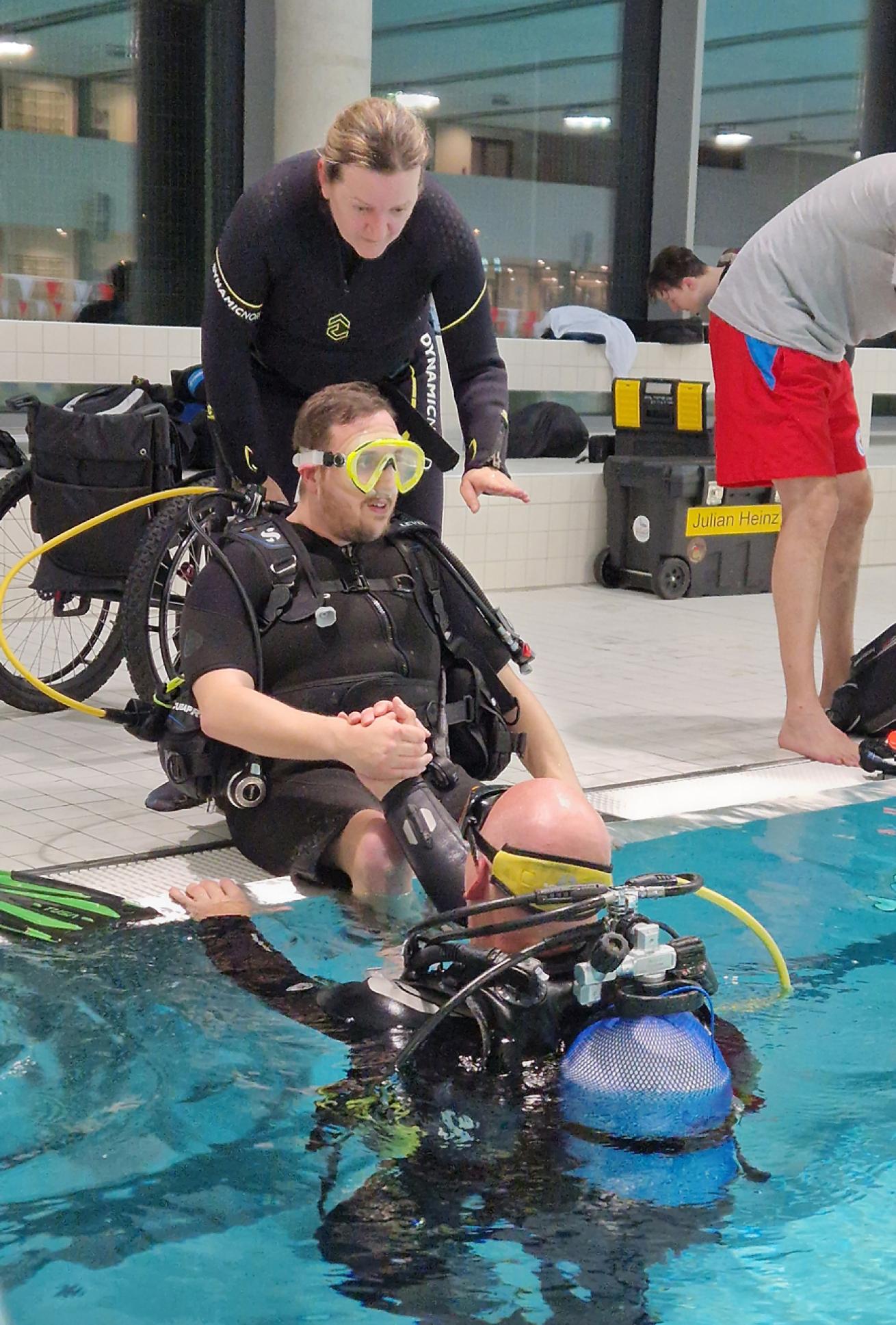 Nicole Krass helps a diver with cerebral palsy