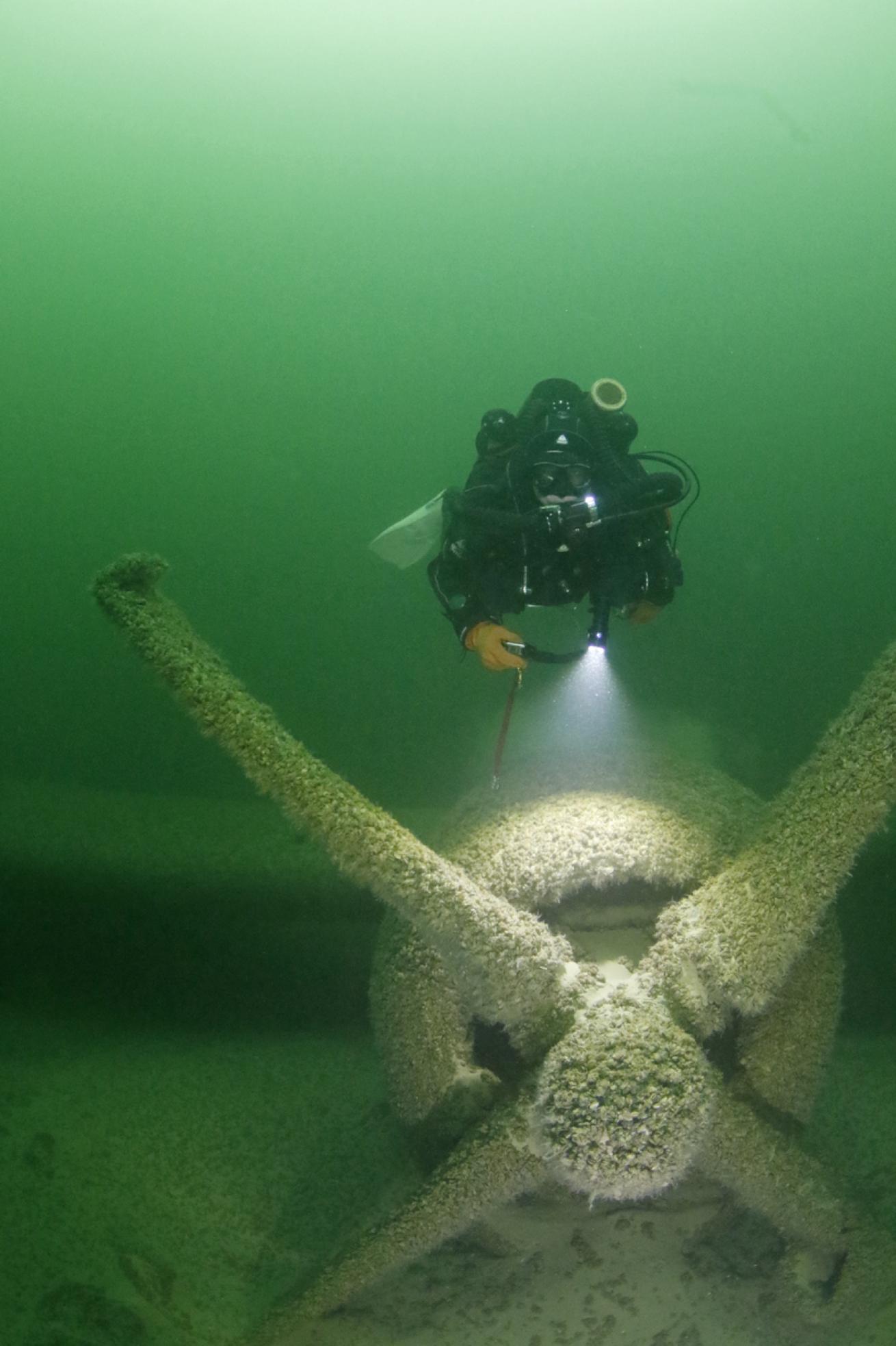 A diver hovers just above a propeller attached to the lake’s popular B-29 wreck

