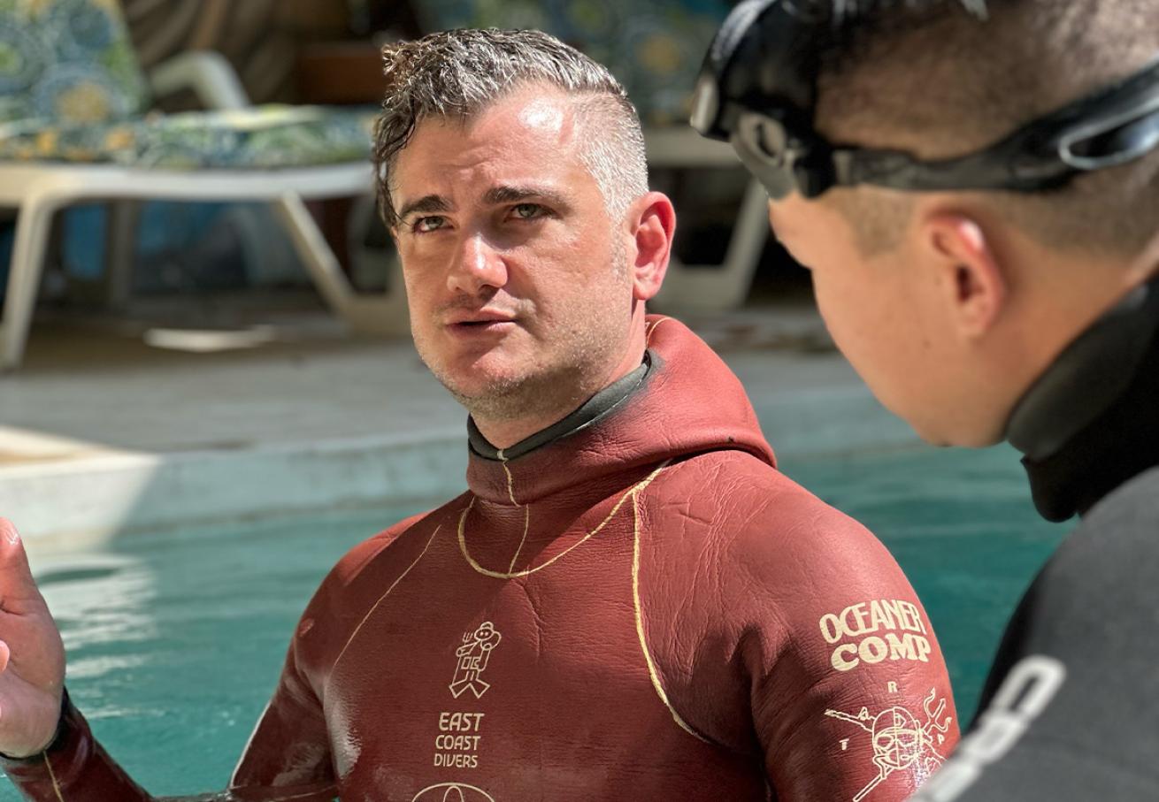 two freedivers training in a poool