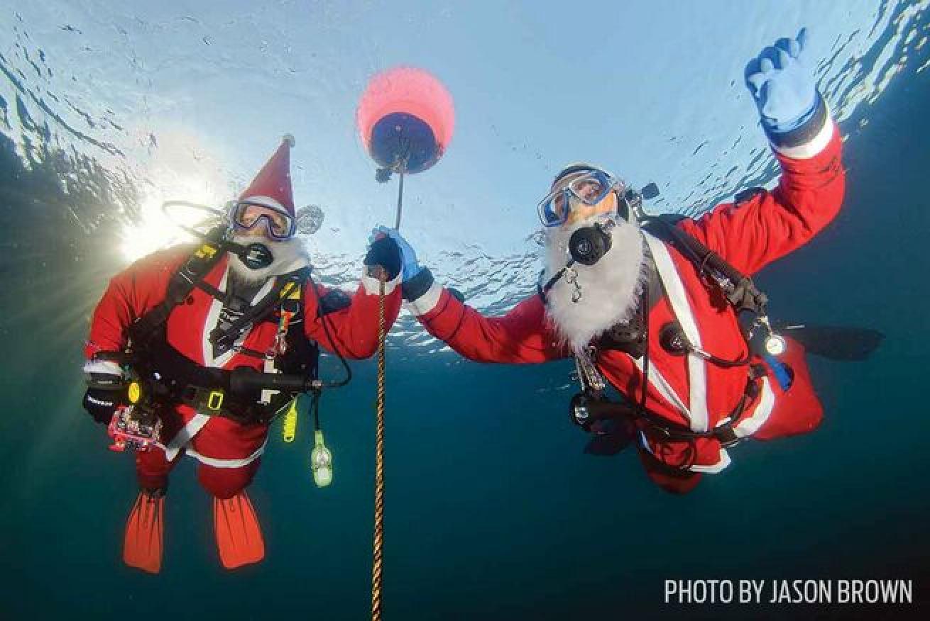 Two divers take part in a Guinness World Record attempt for most scuba diving santas.