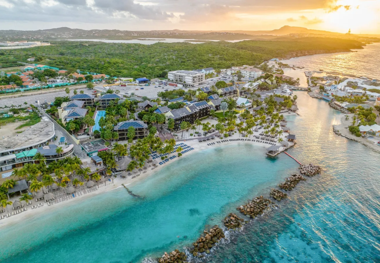 A beach with buildings and a body of water