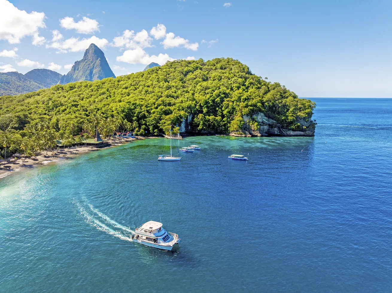 St. Lucia's iconic Pitons rise directly above some of the island’s best dive sites, with Anse Chastanet Resort curled close by