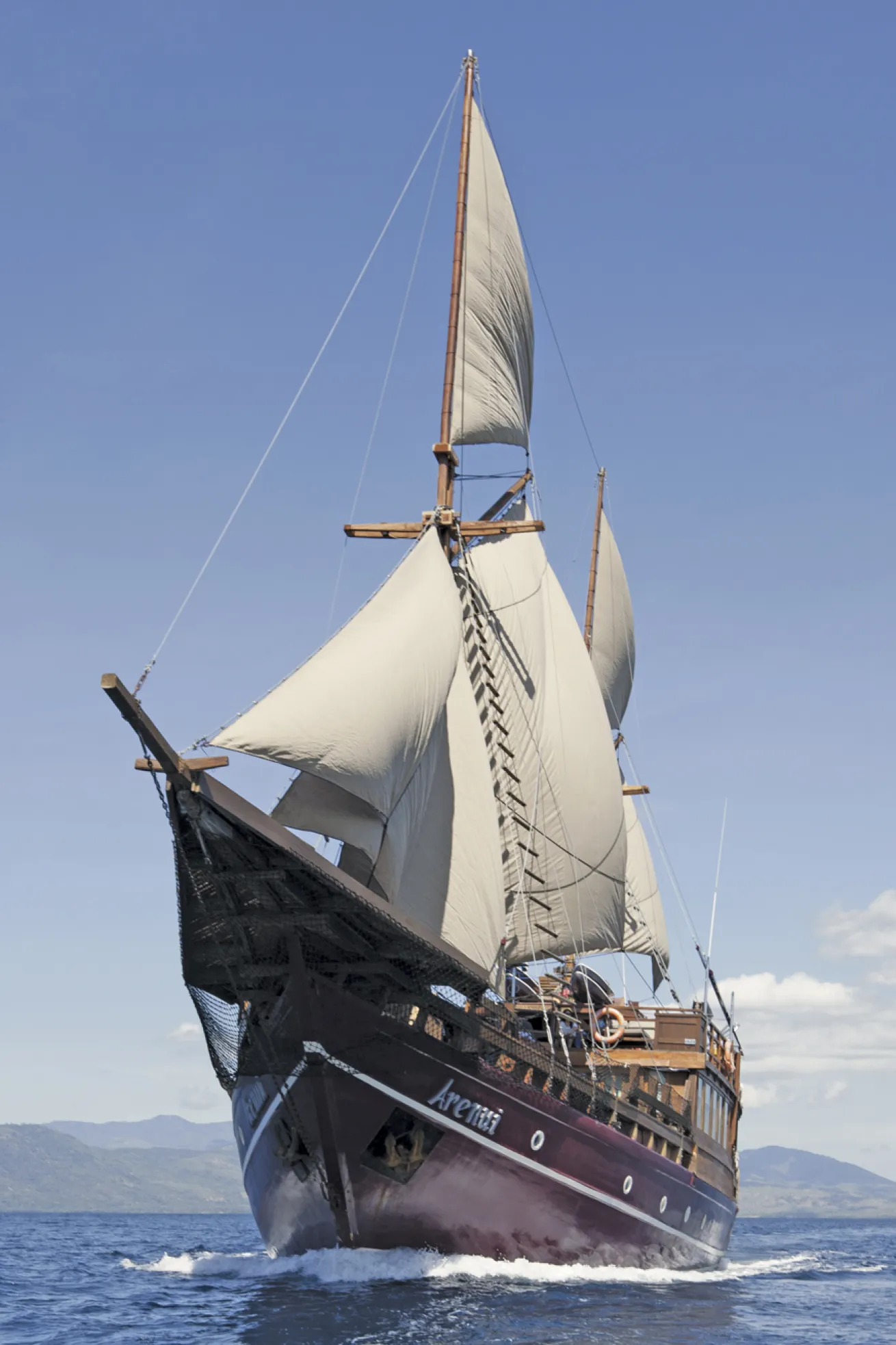 *Arenui*, a traditional phinisi, was built by 50 skilled artisans in South Sulawesi and features a hand-carved ironwood hull.