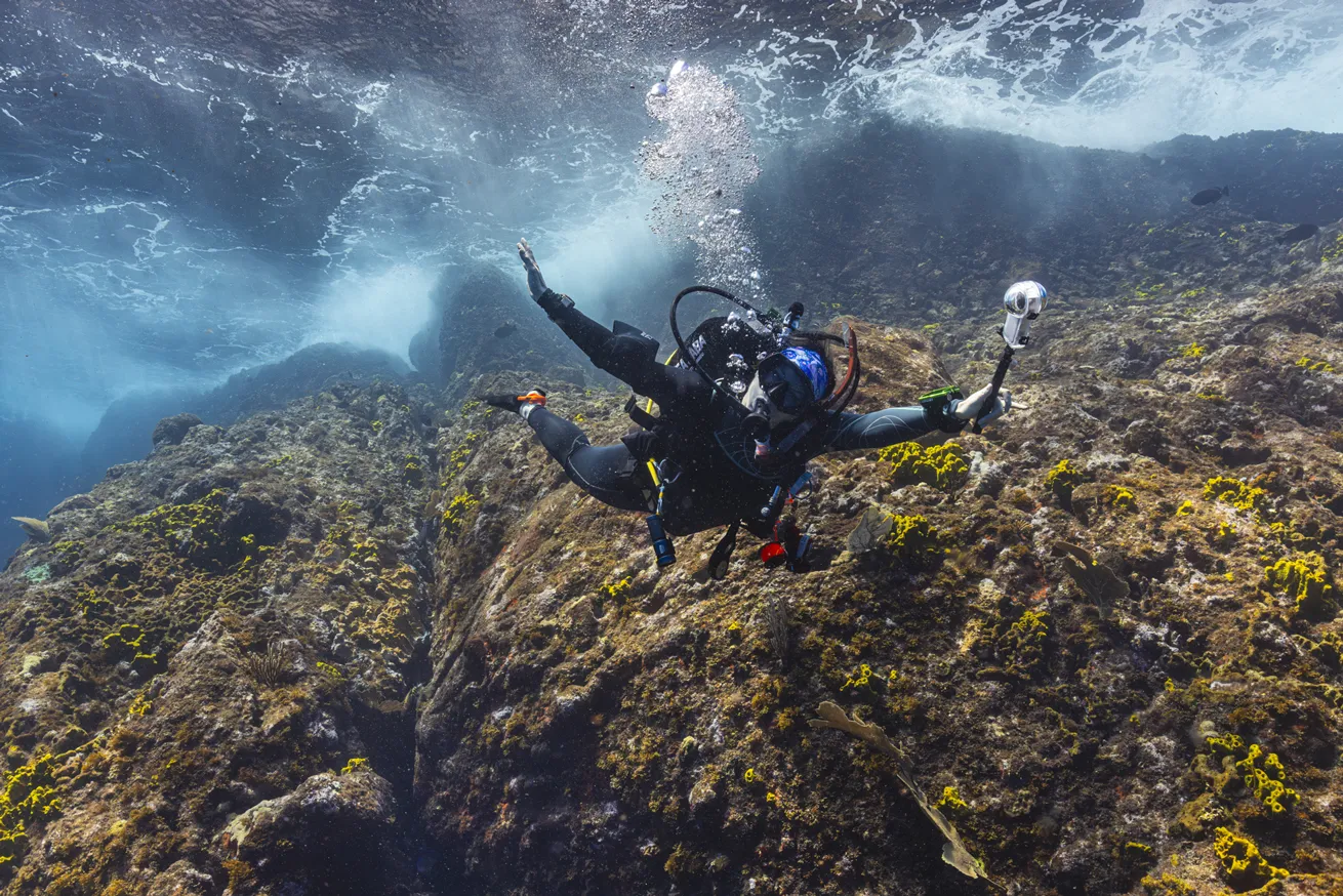 The author, on her last dive, reveling in the freedom of diving sites that make for dramatic photographs like this one.