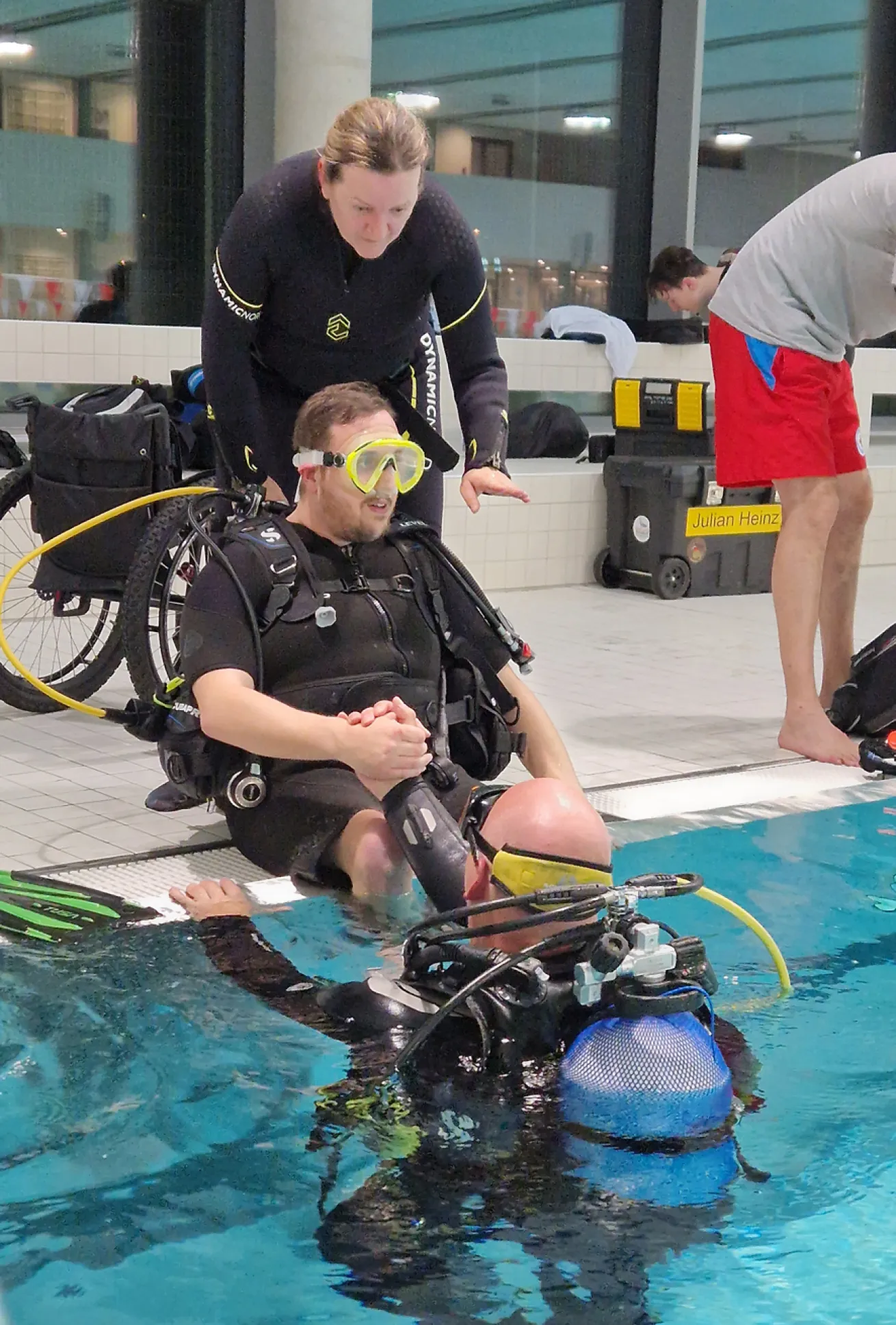 Nicole Krass helps a diver with cerebral palsy