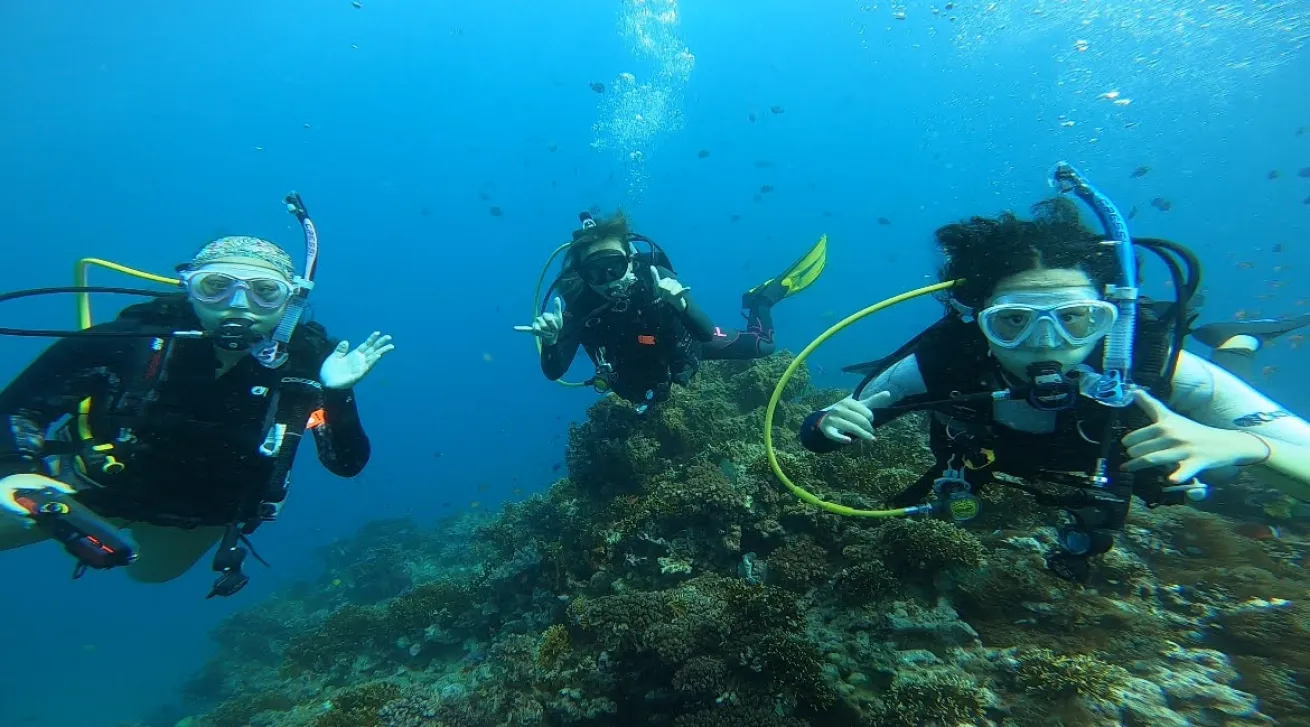 The Espinosa family poses underwater.