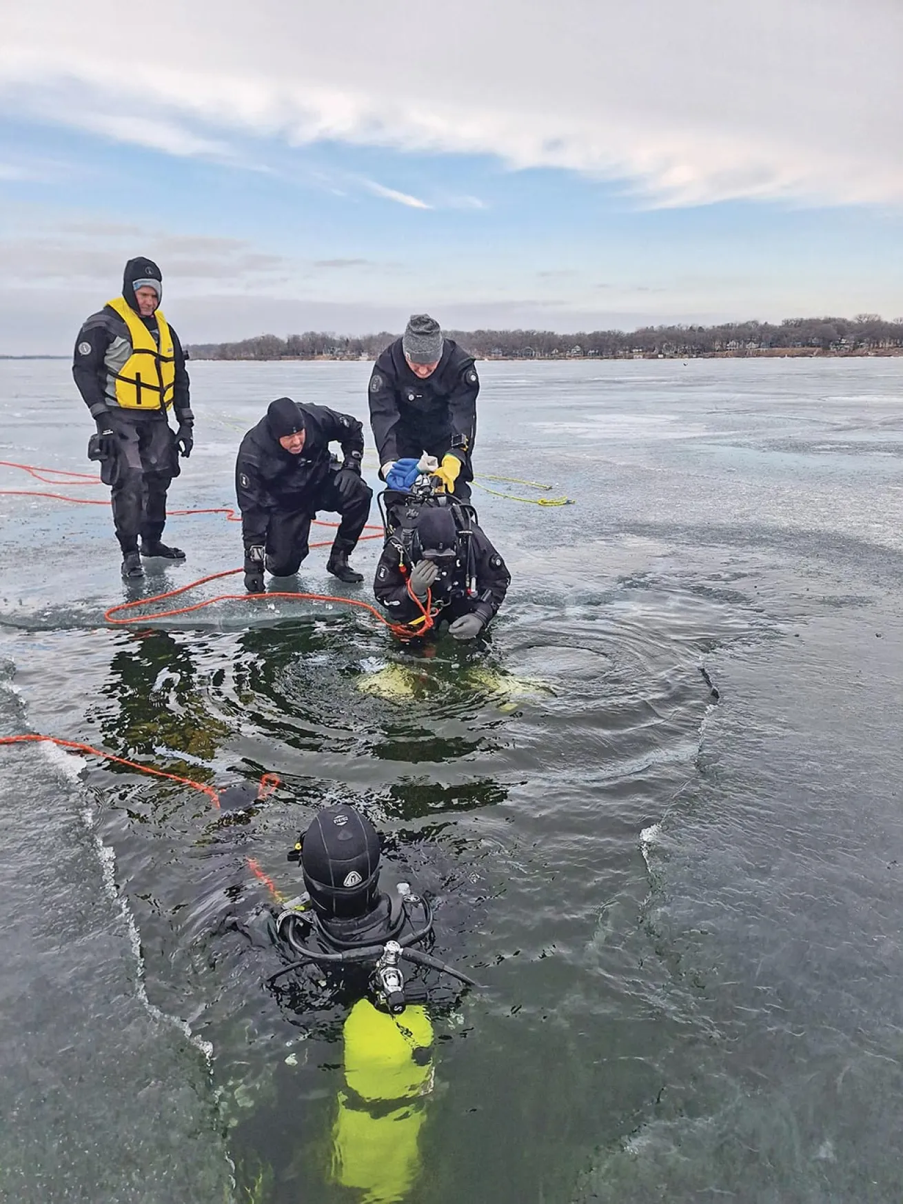 Divers take the plunge into a frigid West Okoboji Lake.