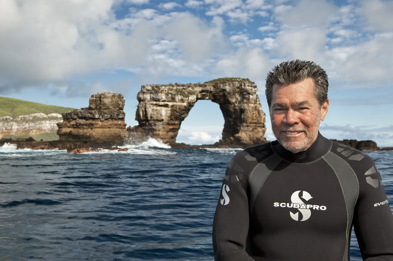 Hughes in front of Darwin’s Arch, Galapagos Islands, which collapsed in 2021 and is now known as Darwin’s Pillars.