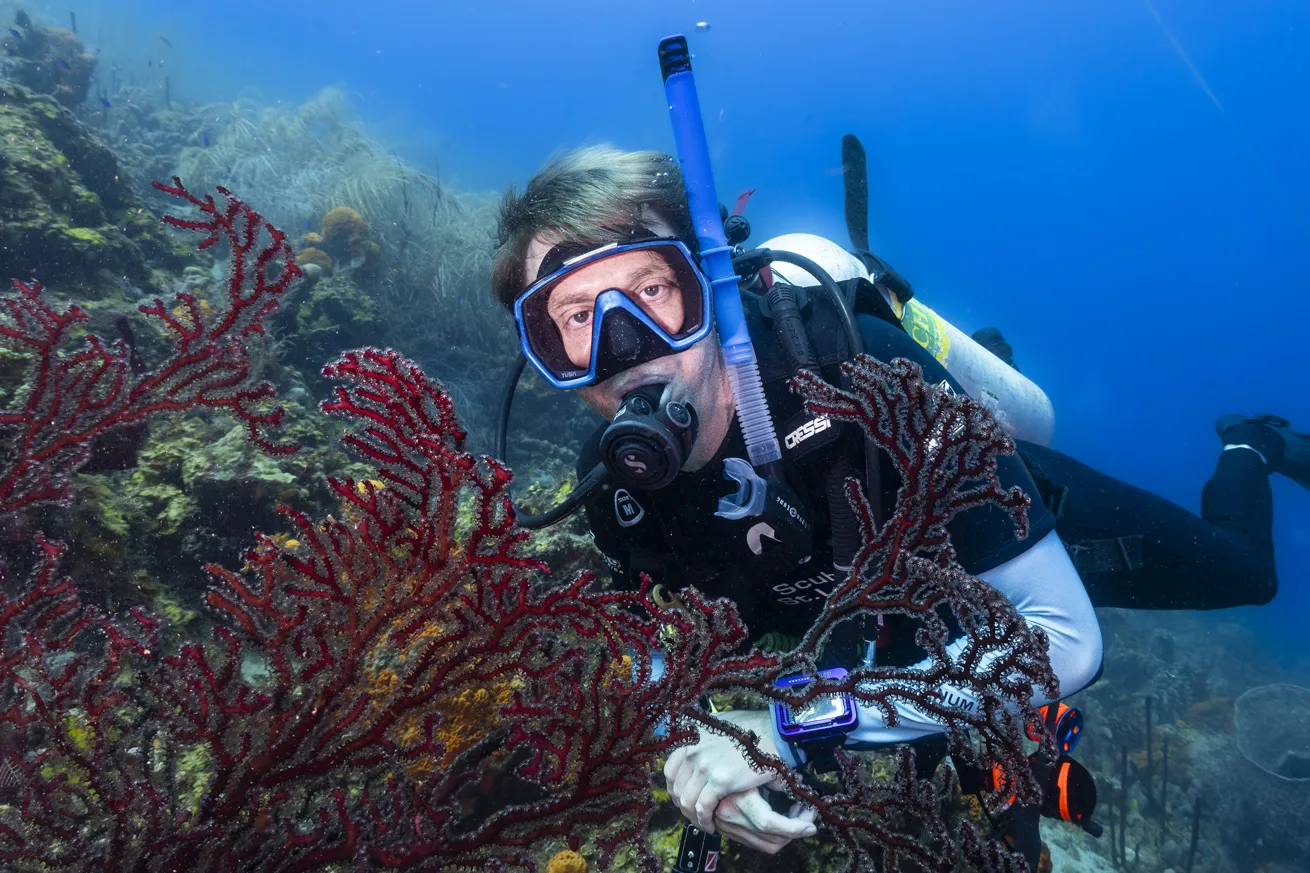 The author’s partner poses next to a beautiful sea fan.