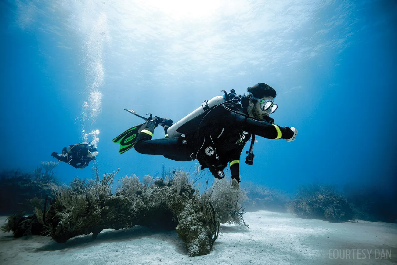scuba diver checking dive computer 