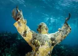 an underwater photo of the Christ of the Abyss