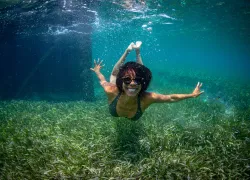 ayana-johnson-swimming-seagrass-credit-jeremy-mckane.jpg.webp