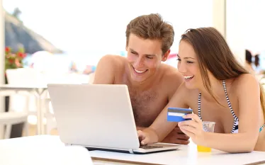 couple-online-shopping-beach-shutterstock-antonio-guillem.jpg.webp
