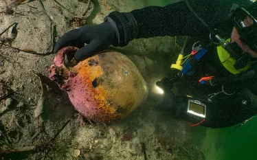diver-with-wreckage-erling-tonnessen.jpg.webp