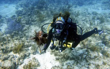 florida-keys-lionfish-female-diver-.jpg.webp