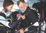 two_divers_gearing_up_and_conducting_a_predive_safety_check_edit.jpg.webp